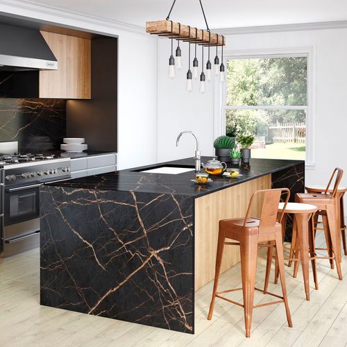 an image of a kitchen with marble countertops and wooden stools in the middle