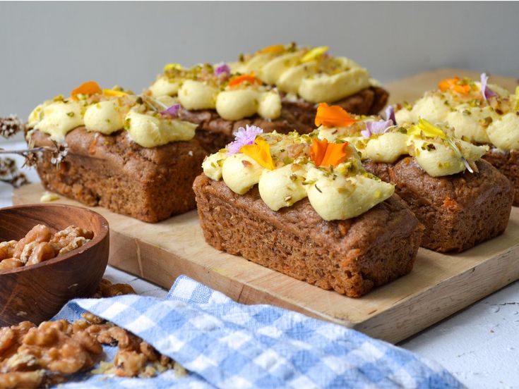 several pieces of cake sitting on top of a wooden cutting board