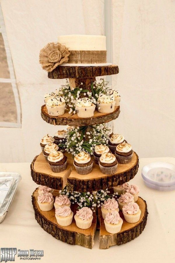 cupcakes are stacked on top of each other in the shape of a tree