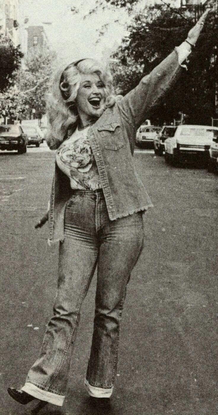 a woman riding a skateboard down a street