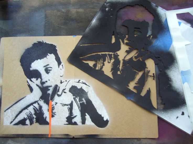 some stencils are laying on top of a piece of paper that has been altered to look like a man