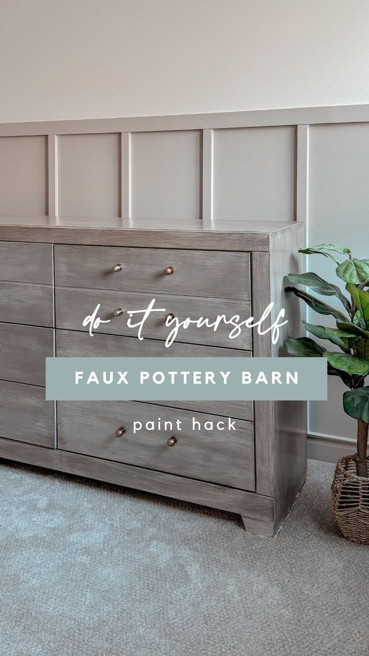 a grey dresser with the words faux pottery barn painted on it and a potted plant next to it