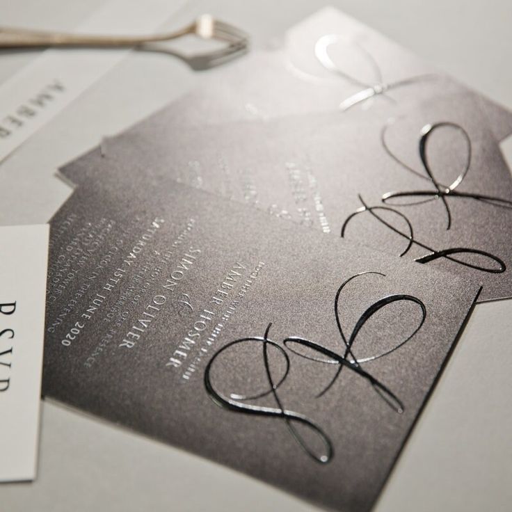 a close up of a business card on a table with scissors and napkins next to it