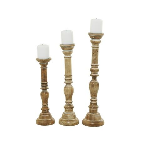 three wooden candlesticks sitting next to each other