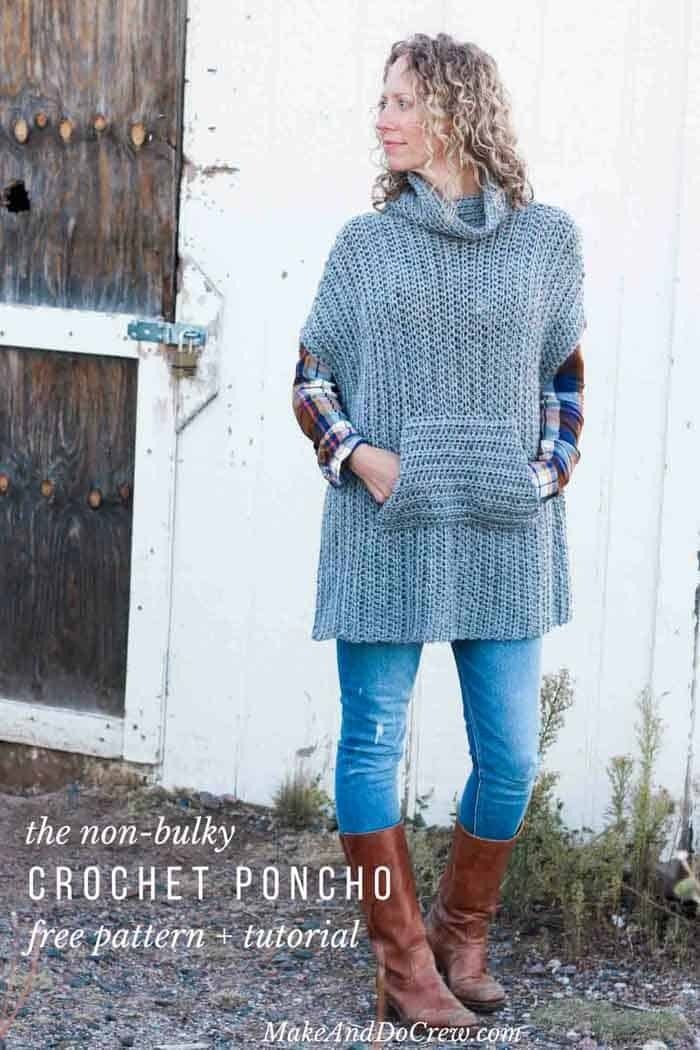 a woman standing in front of a barn wearing boots