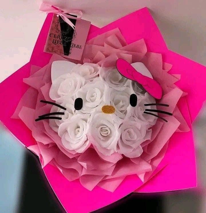 a pink paper flower bouquet with a hello kitty face on it