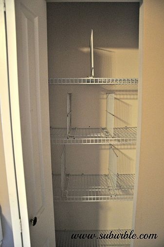 an empty closet is shown with the door open and shelves in place for items to be stored