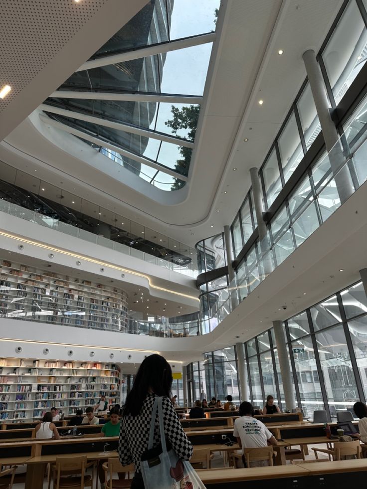 a woman is standing in the middle of a library