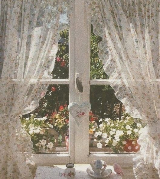 an open window with curtains and flowers on the windowsill, in front of a tea pot