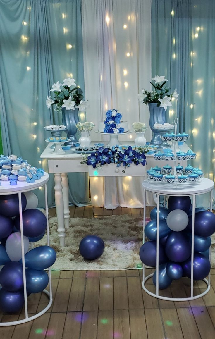 blue and white dessert table set up with balloons