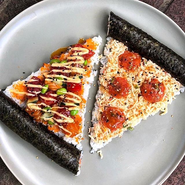 two pieces of sushi on a plate with sauce and toppings, ready to be eaten