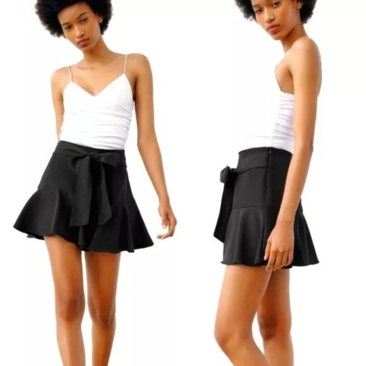 Zara Black Bow Trim Ruffle Mini Skort Skirt With Bow Belted /Size M New With Tags Black Skort Size M Ref: 3666/222 Art: 1165/240/800 No Returns Add A Touch Of Elegance To Your Wardrobe With This Stunning Black Mini Skirt Skort From Zara. The Skirt Is Made Of High-Quality Polyester Knit Fabric Which Makes It Comfortable To Wear All Day. The Solid Pattern Gives It A Classic Look While The Ruffle And Bow Accents Provide A Feminine Touch. The Mid-Rise Skirt Has A Zip Closure And Comes With A Belt To Chic Fitted Skort For Brunch, Chic Short Skirt With Ruffle Hem, Elegant Black Skirt For Brunch, Fitted Black Bottoms For Brunch, Chic Skort With Ruffle Hem, Chic Skort With Ruffle Hem And Flared Skirt, Chic Flared Skort With Ruffle Hem, Chic Ruffled Skirt For Date Night, Chic Flared Skort For Brunch