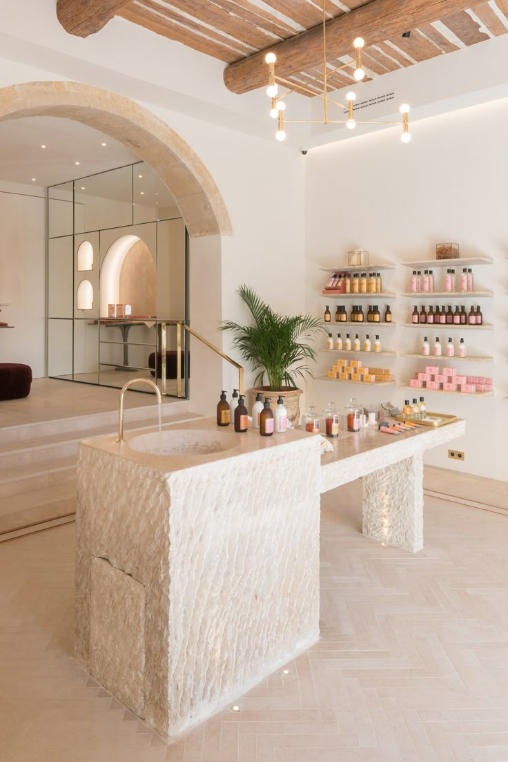 the inside of a store with shelves and bottles on display in front of an arched doorway