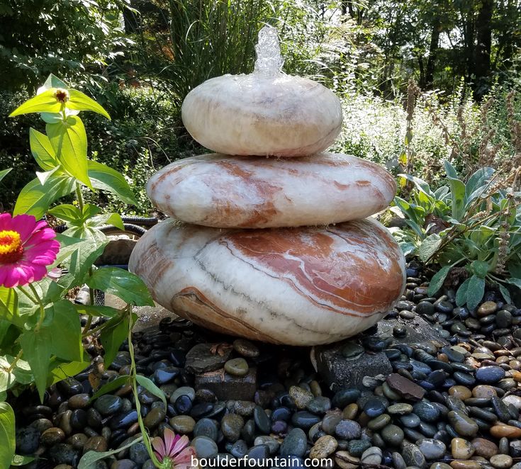 a stack of rocks sitting in the middle of a garden