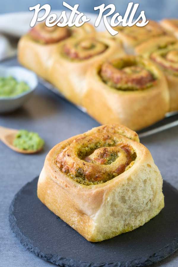 there is a roll with pesto in it on a plate next to other rolls