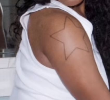 a woman with a star tattoo on her arm