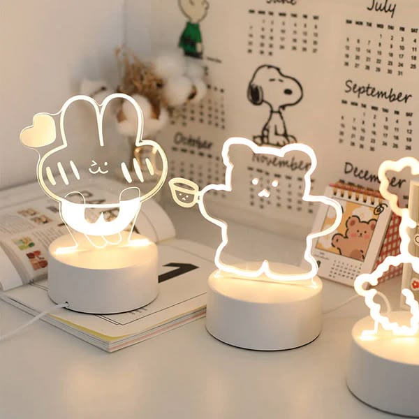 three little lamps that have been placed on a desk with the lights turned on to look like animals