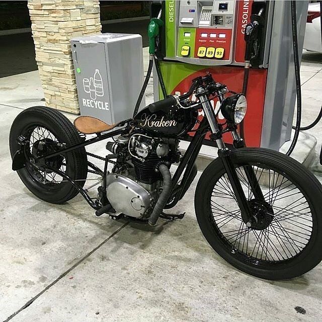 a motorcycle parked next to a gas pump