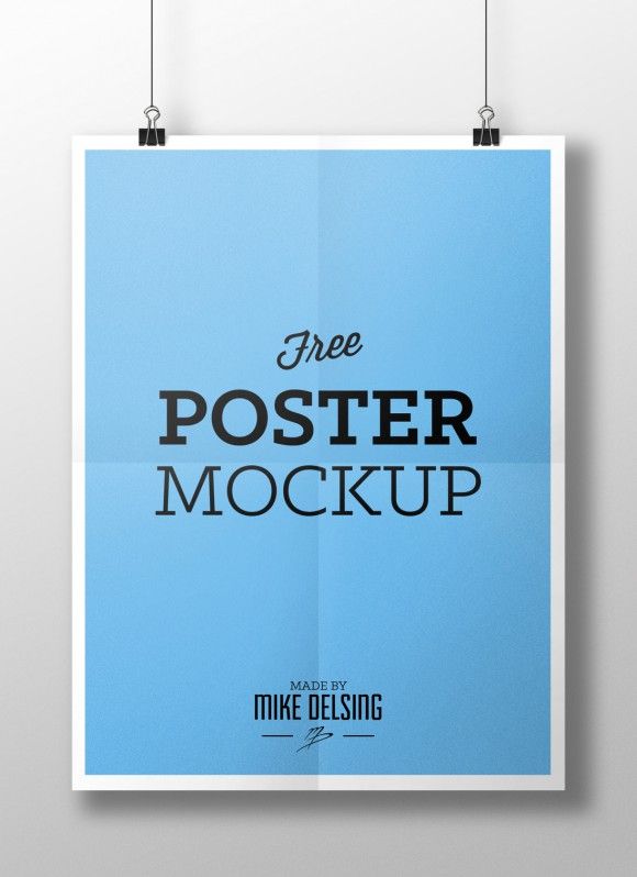 a blue poster hanging on a wall with the words free poster mockup