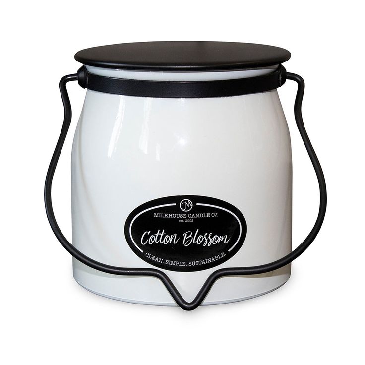 a white and black canister sitting on top of a table