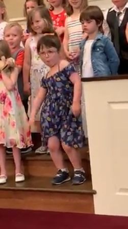 a group of children standing on top of a set of stairs next to each other