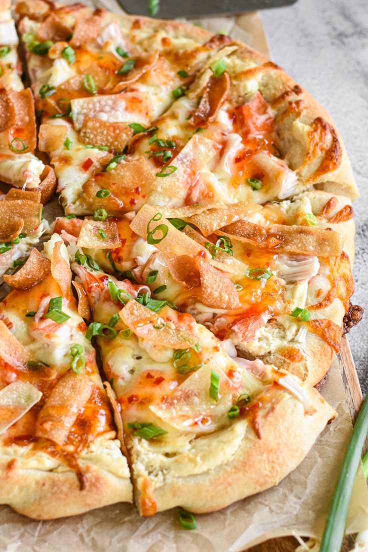 a pizza sitting on top of a wooden cutting board