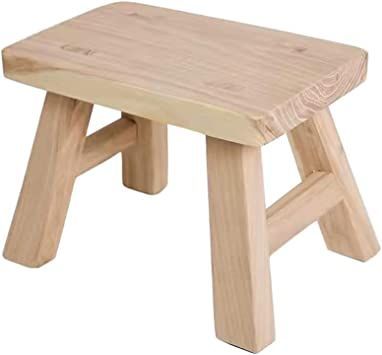 a small wooden stool sitting on top of a white background