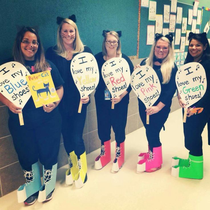 five girls in black outfits holding signs that read i love my blue spot