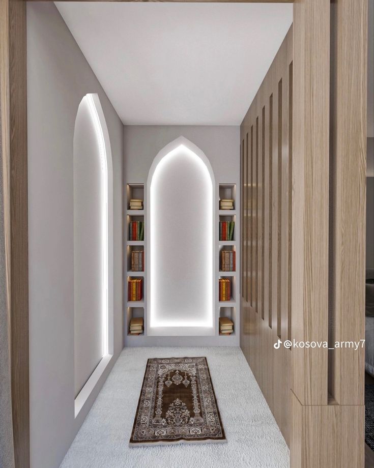 the hallway is decorated with bookshelves, rugs and lights on either side