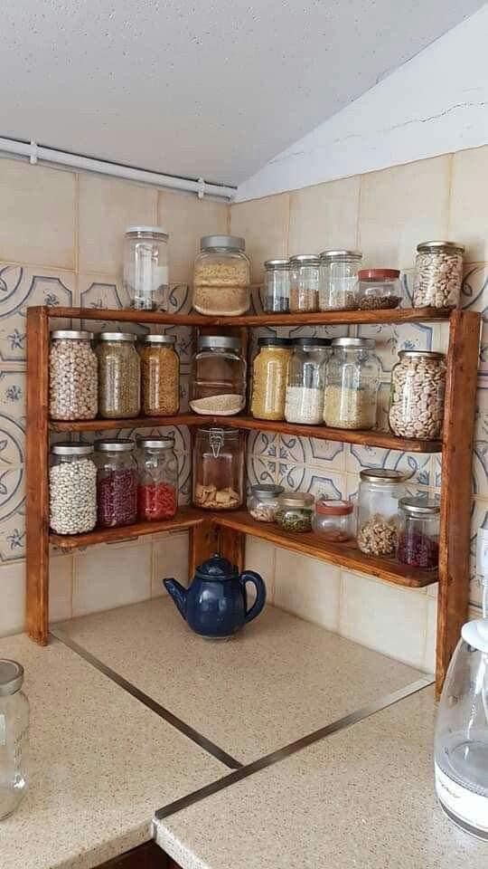 a kitchen with lots of jars and containers on the shelves