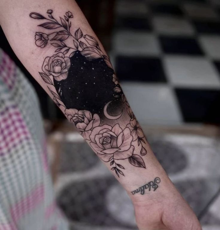 a person with a black and white tattoo on their arm