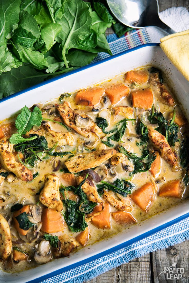 a casserole dish with chicken, spinach and cheese