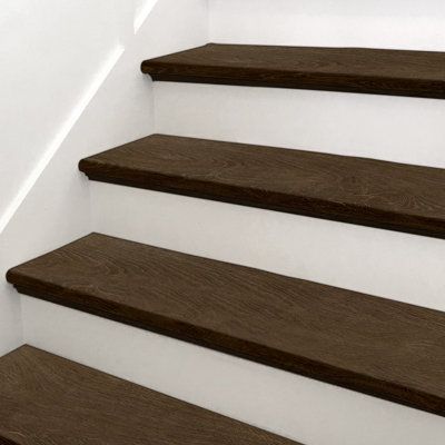 the stairs are made of wood and have white walls