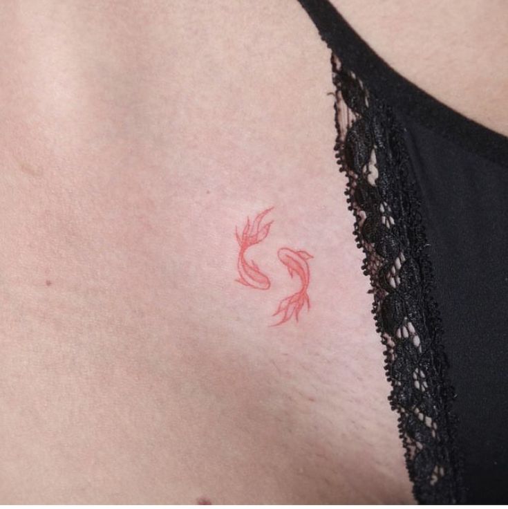 a woman's chest with red ink on it