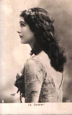 an old black and white photo of a woman with long hair wearing a lace dress