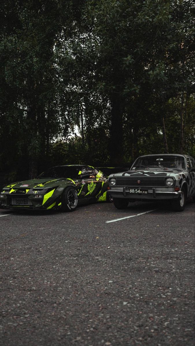 two cars parked next to each other in a parking lot