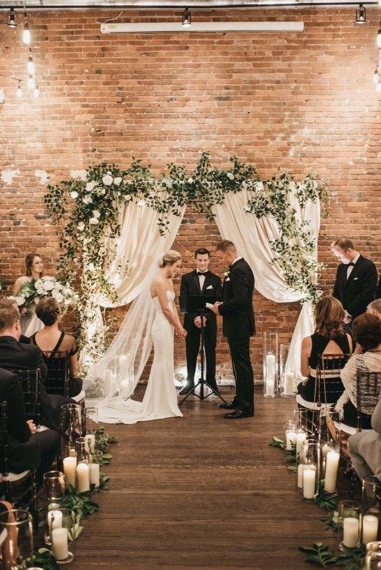 a bride and groom kissing in front of their wedding guests