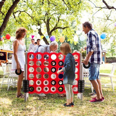 a group of people standing around a giant game