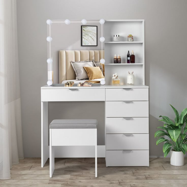 a white desk with drawers and a mirror on it next to a potted plant