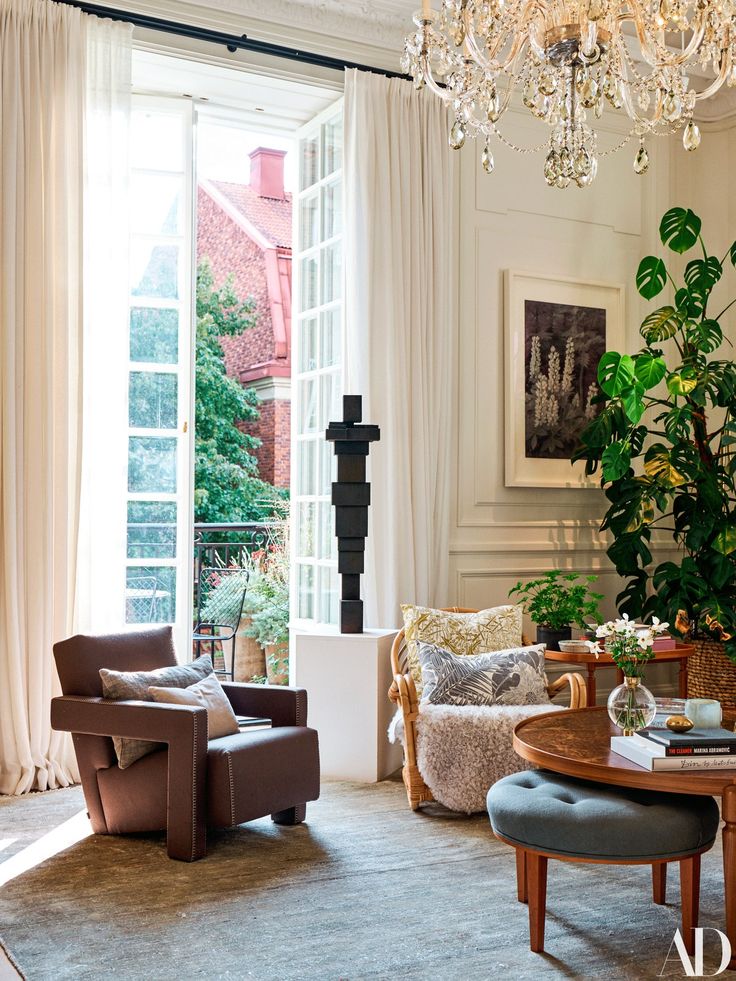 a living room filled with furniture and a chandelier