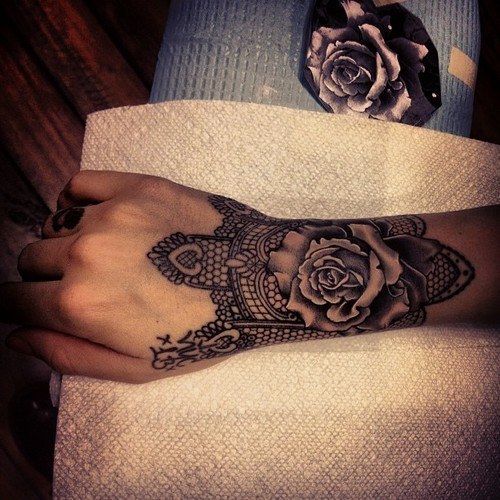 a woman's arm with a tattoo on it and a rose in the middle