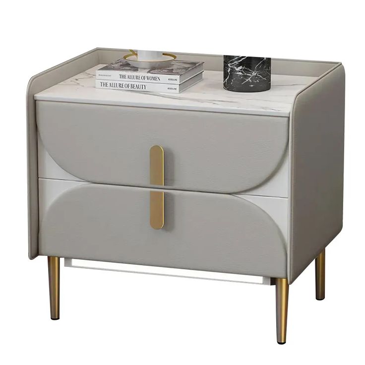 a white and gold nightstand with books on top