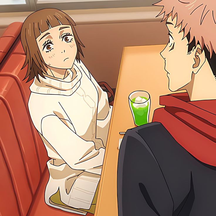 two people sitting at a table with drinks