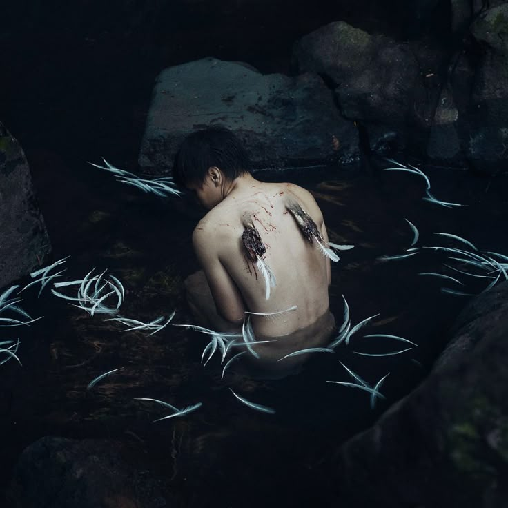 a man is in the water with his head covered by barbed wire as he swims