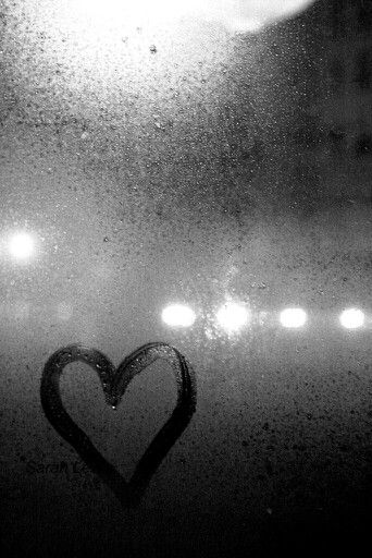 a black and white photo with a heart drawn on the window