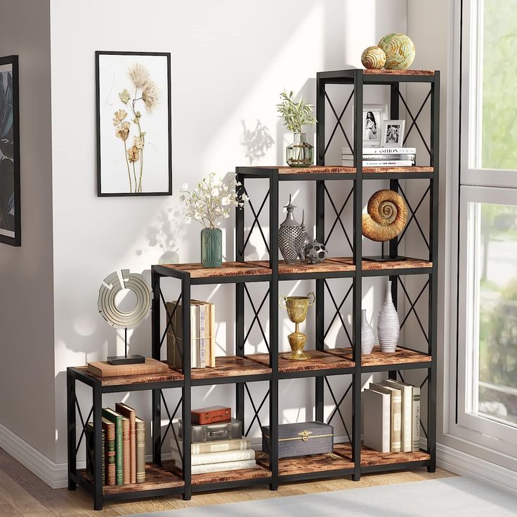 a bookshelf with several shelves and pictures on the wall in front of it