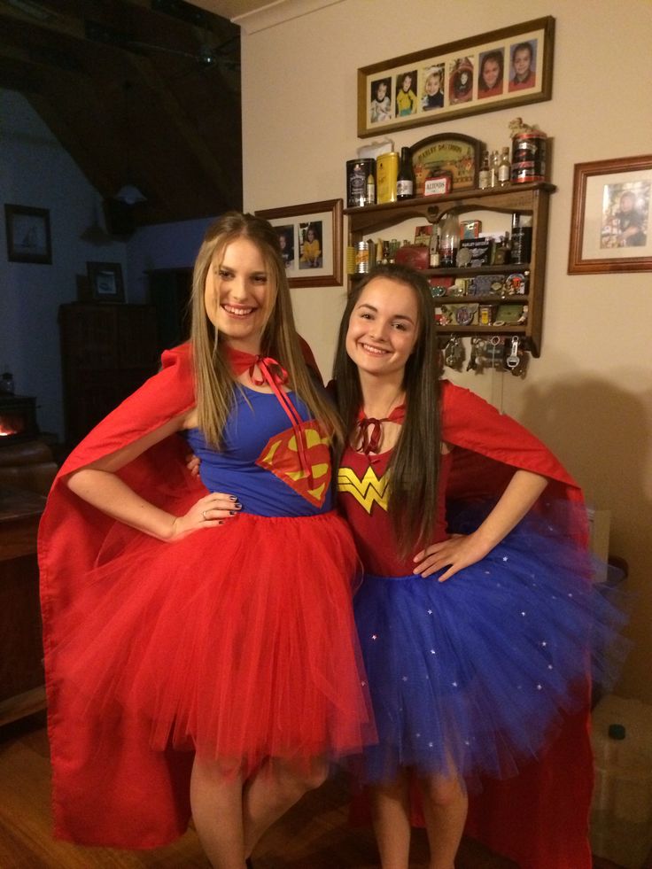 two girls dressed in costumes posing for the camera