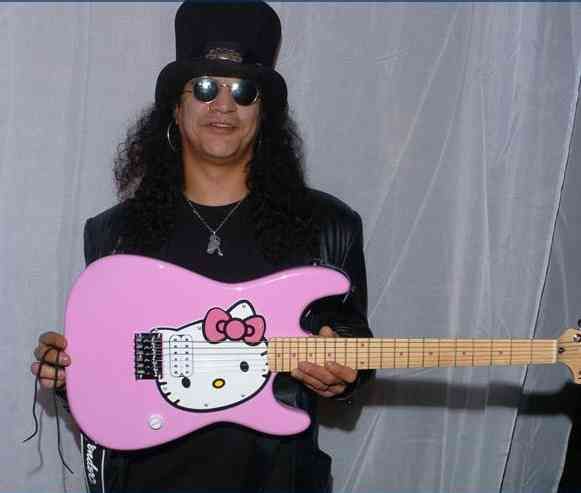 a man in a hello kitty outfit holding a pink guitar