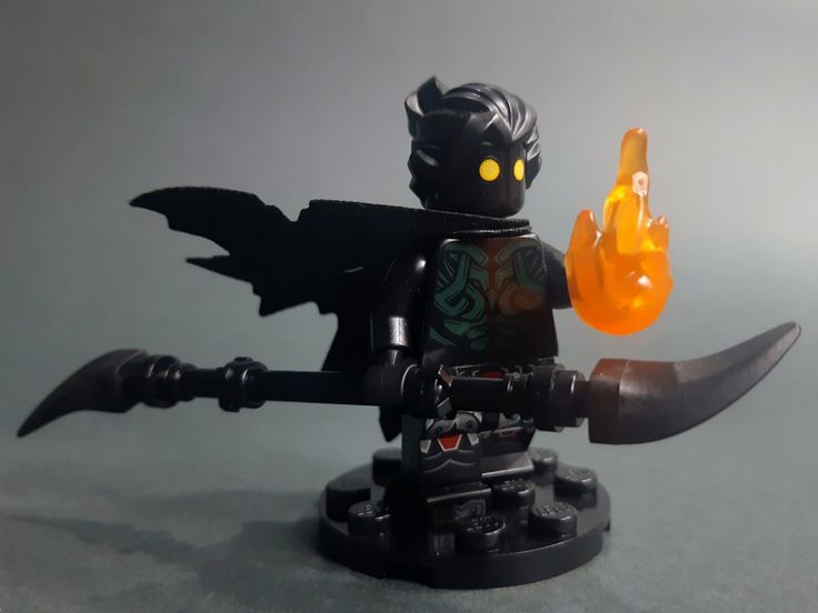 a lego figure holding an orange object in his hand