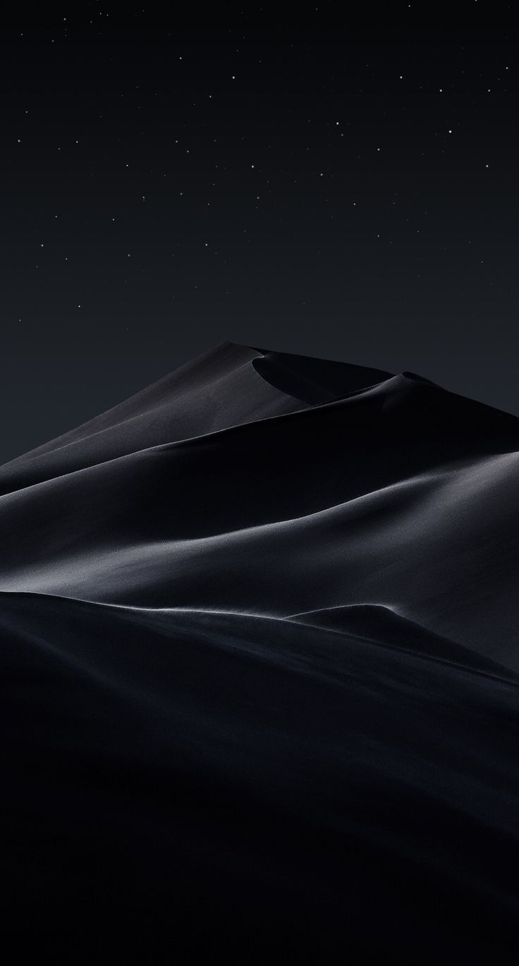 the night sky is lit up by stars above a large hill covered in sand dunes